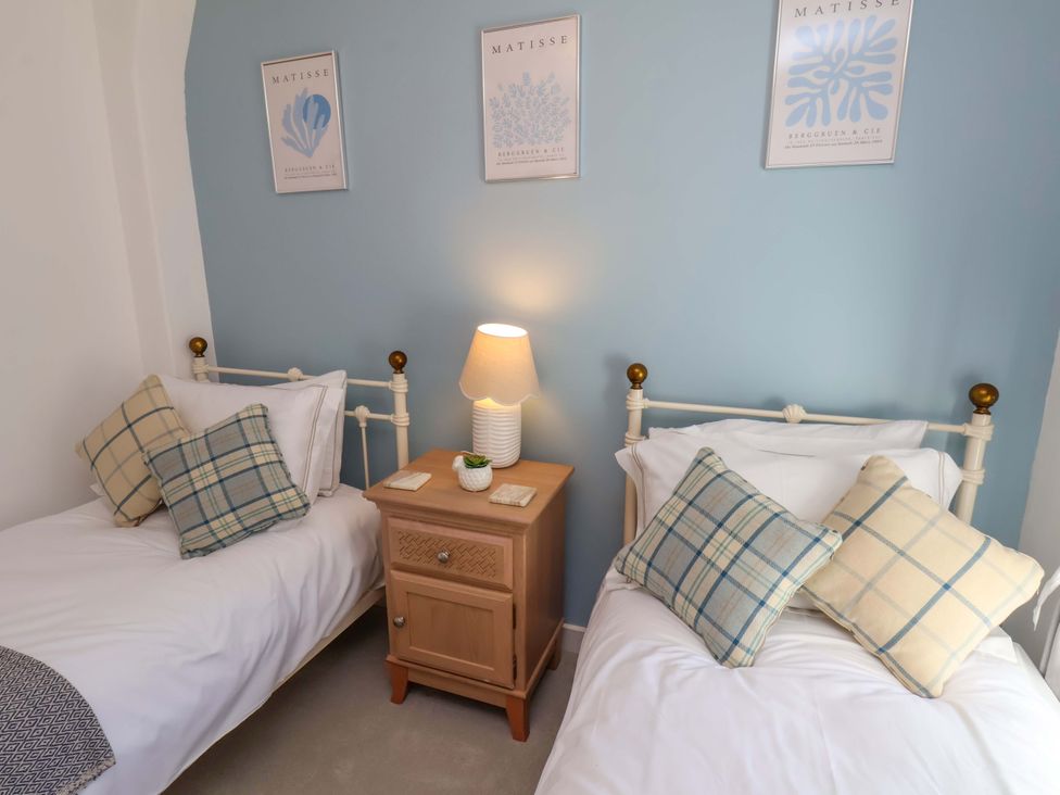 A bedroom with two single beds and a nightstand at 1 Rosedale Abbey