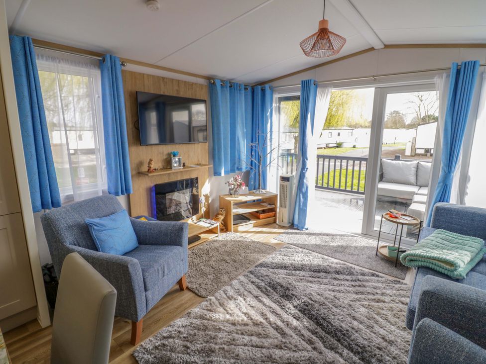 A living room with a sofa and armchair at AV18 Tiddington