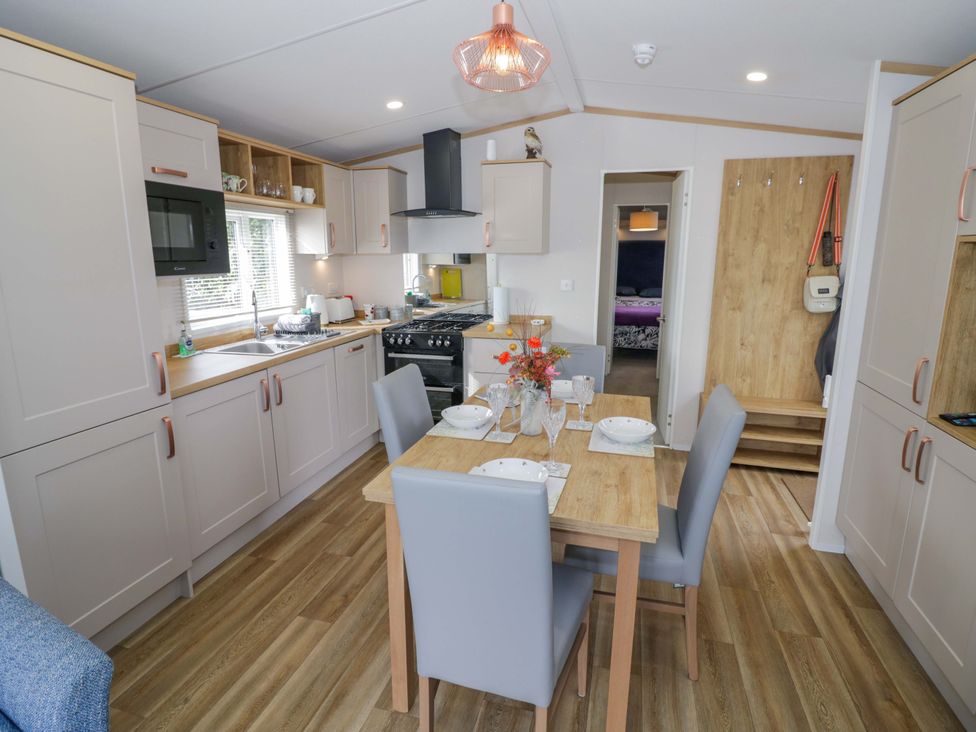A kitchen with a dining table and chairs at AV18 in Tiddington