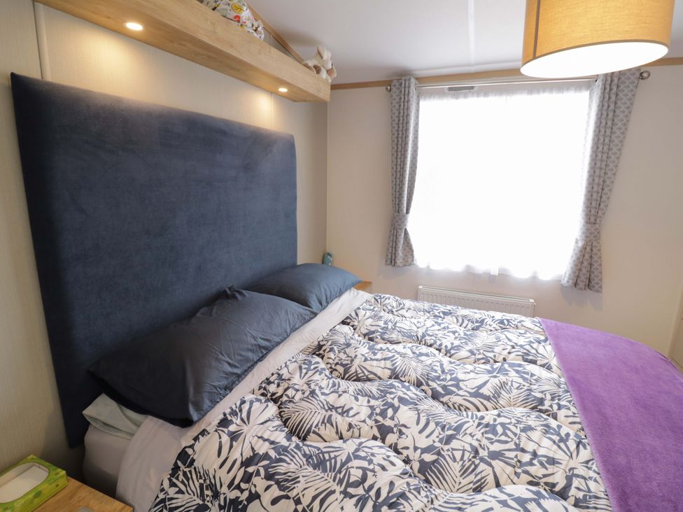 A bedroom with a bed and window at AV18 in Tiddington