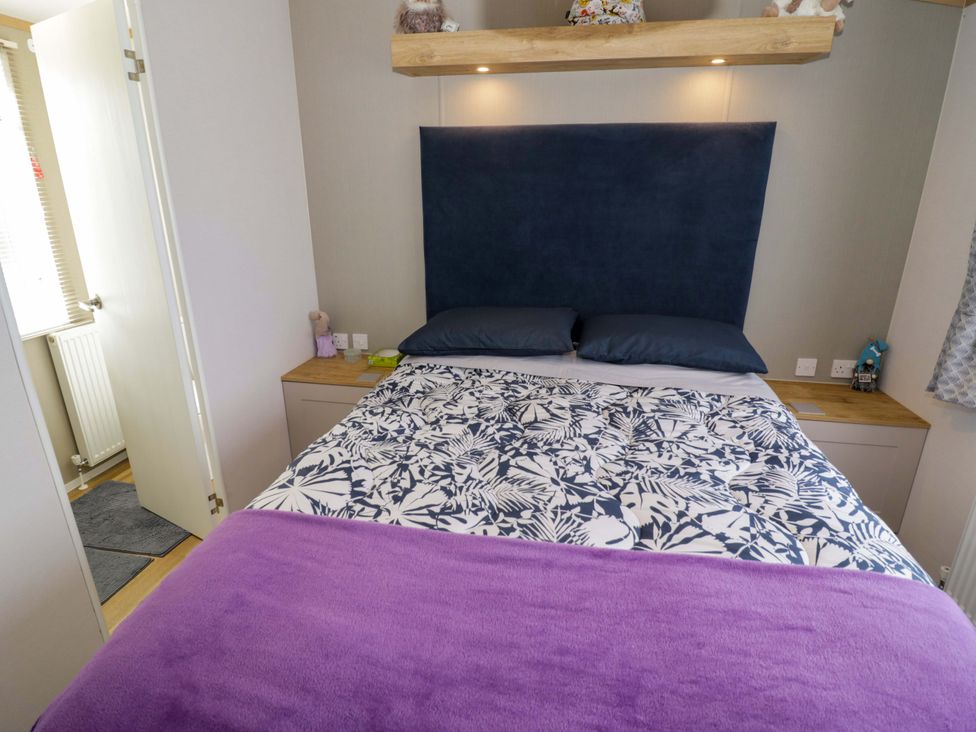 A bedroom with a bed and bedside table at AV18 in Tiddington