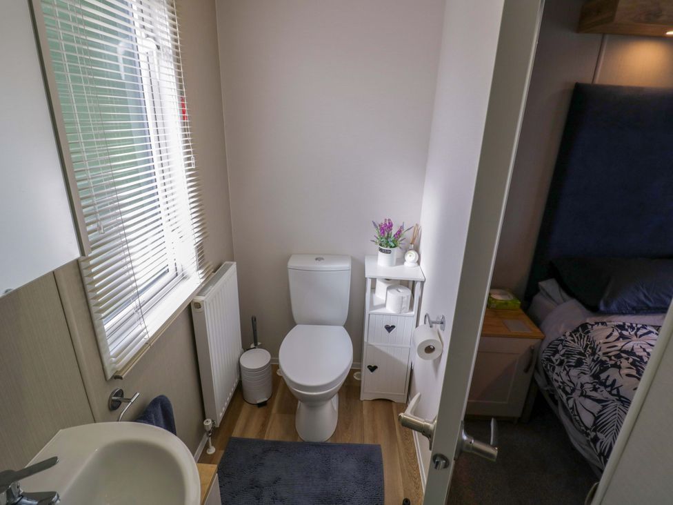 A bathroom with a toilet and sink at AV18 in Tiddington