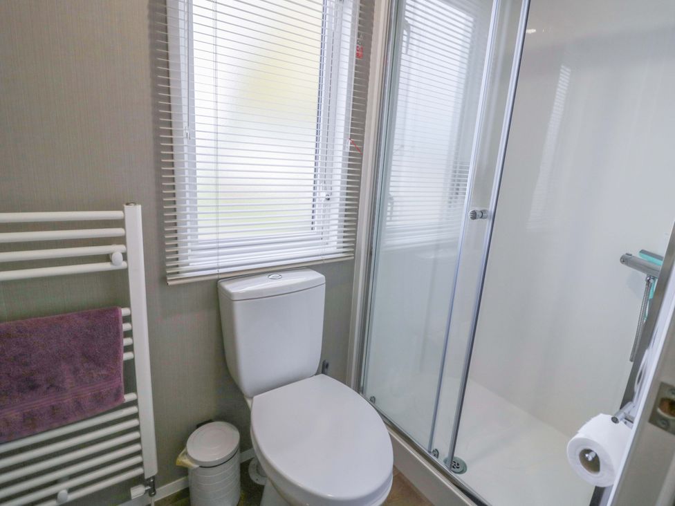 A bathroom with a toilet and shower at AV18 Tiddington
