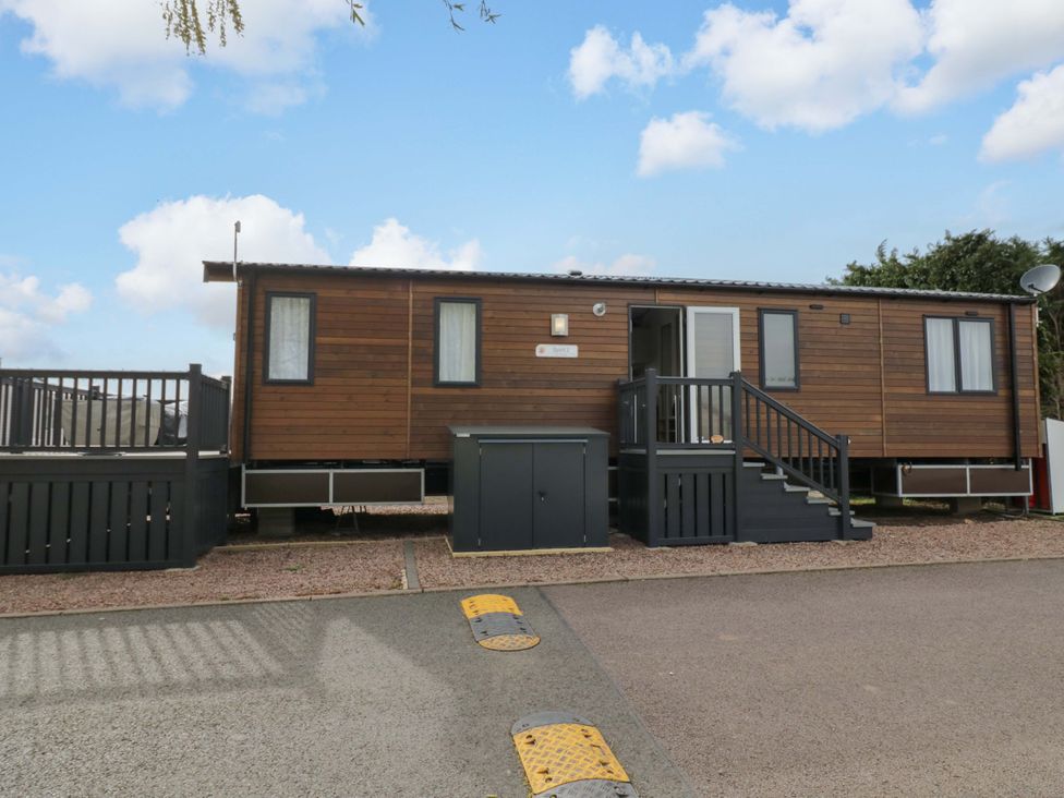 A mobile home with steps and deck at AV18 Tiddington