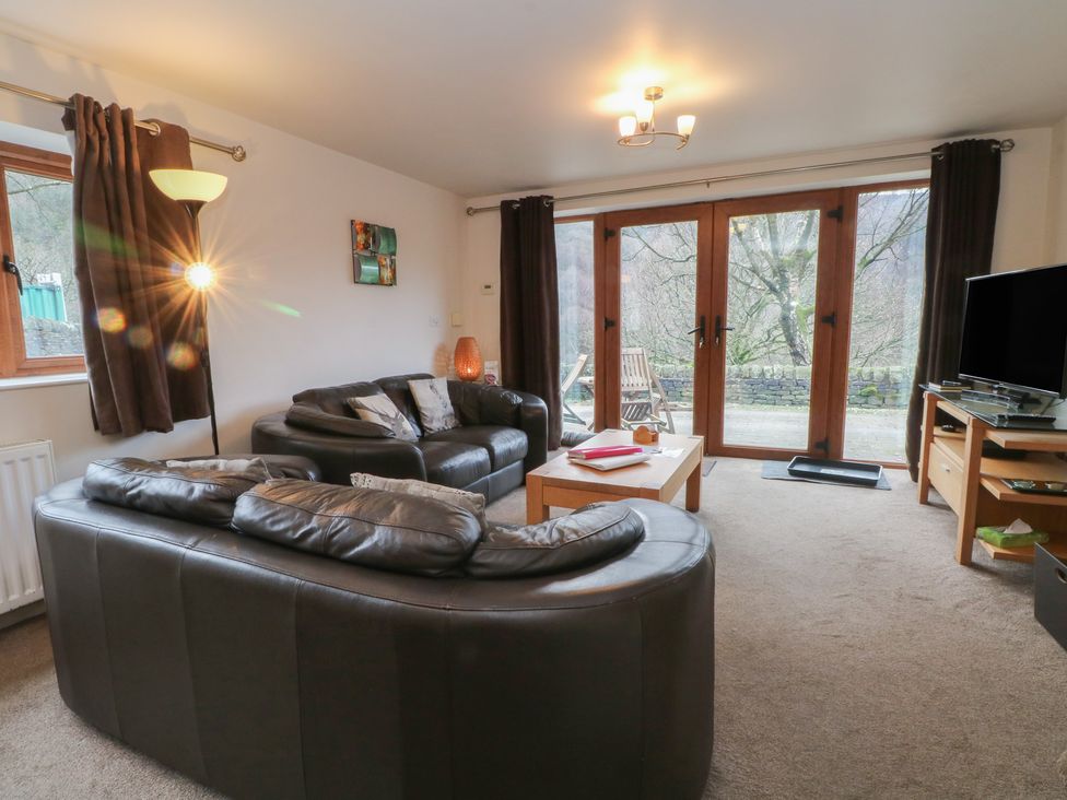 A living room with a sofa and coffee table at Victoria Wood View in Cragg Vale