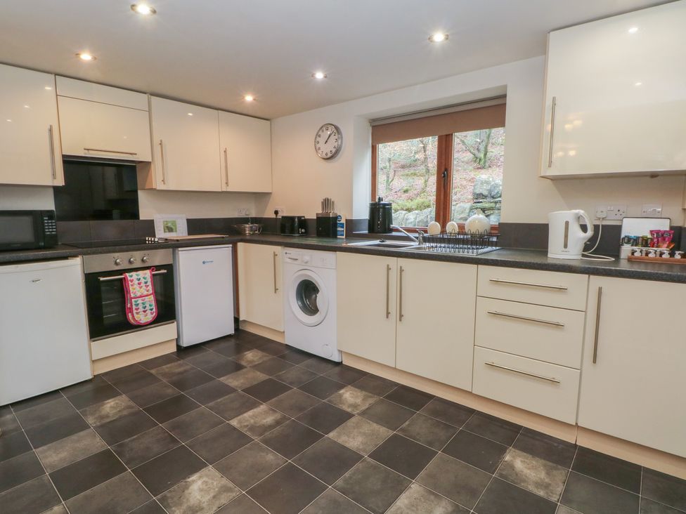 A kitchen with appliances and a window at Victoria Wood View Cragg Vale