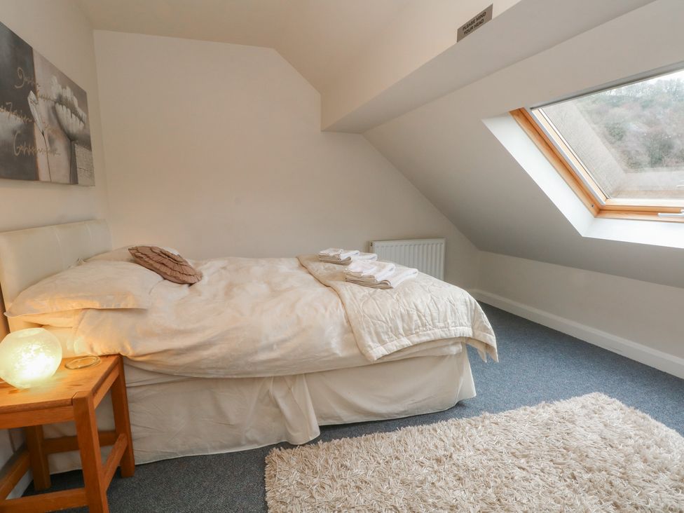 A bedroom with a bed and window at Victoria Wood View Cragg Vale