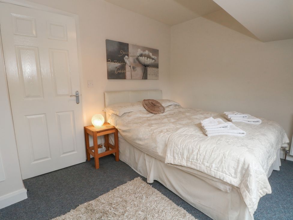 A bedroom with a bed and bedside table at Victoria Wood View in Cragg Vale