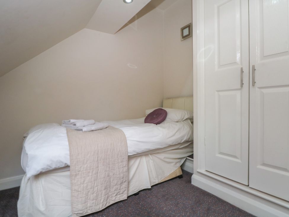A bedroom with a bed and wardrobe at Victoria Wood View Cragg Vale