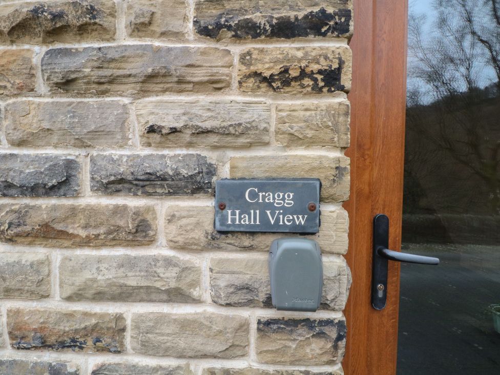 A stone wall with a nameplate at Cragg Hall View in Cragg Vale
