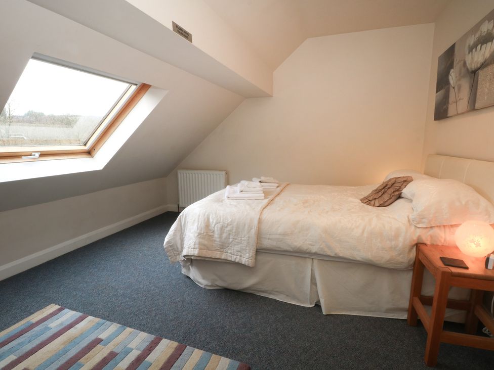 A bedroom with a bed and window at Cragg Hall View in Cragg Vale