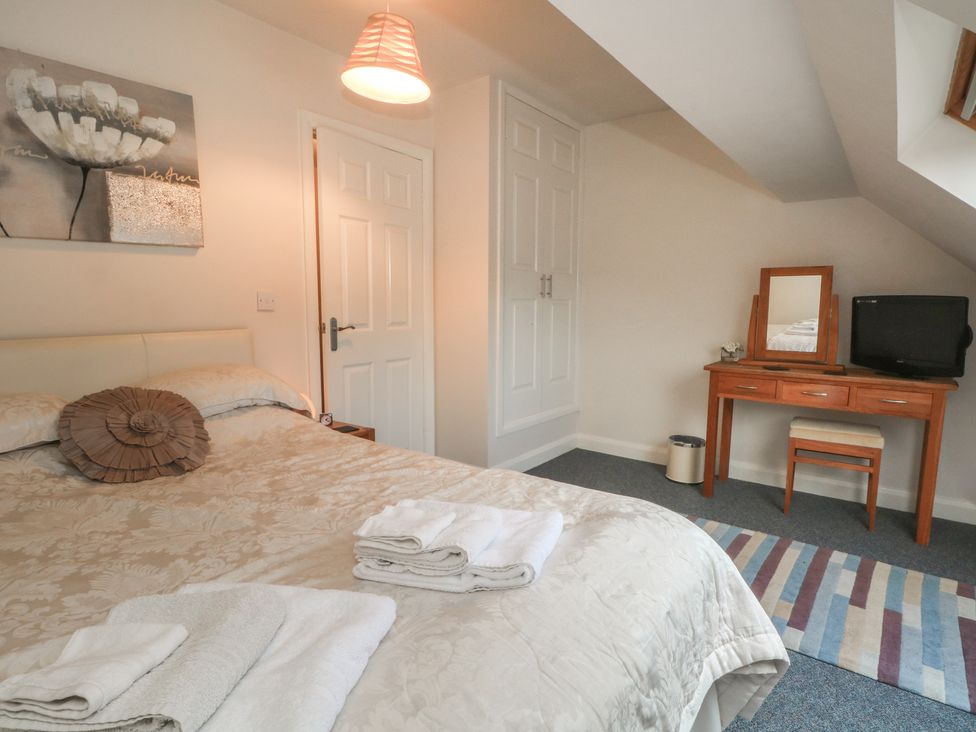 A bedroom with a bed and dresser at Cragg Hall View in Cragg Vale