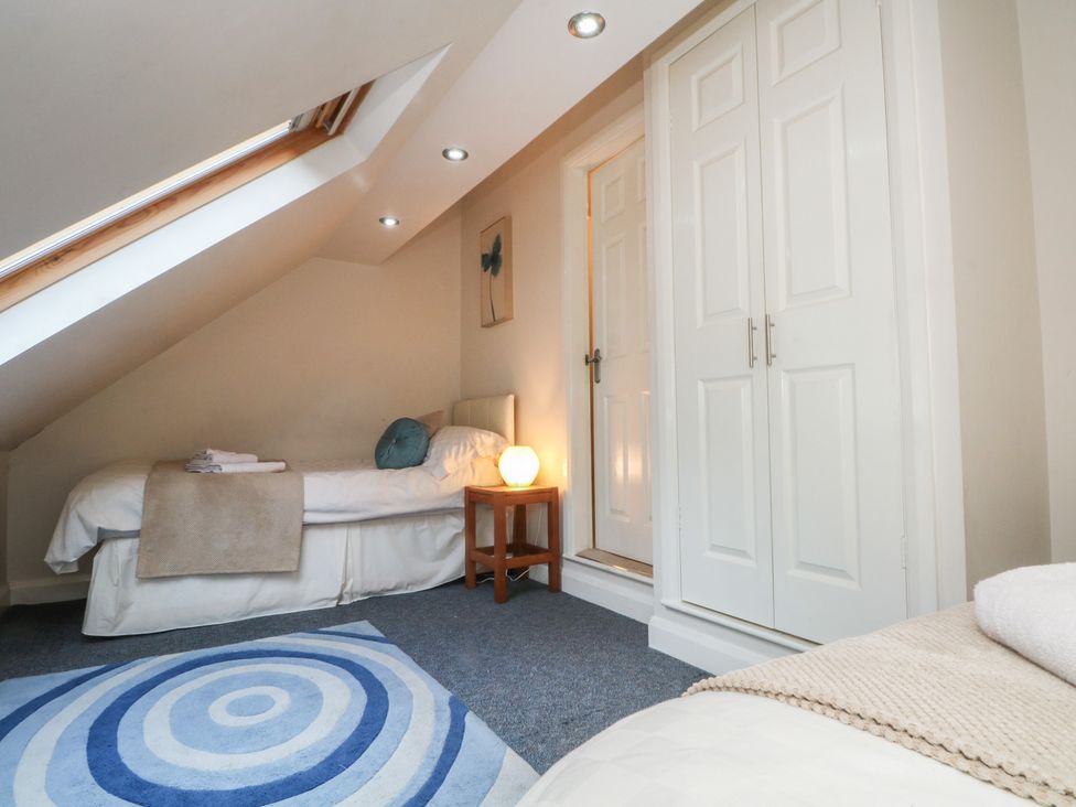 A bedroom with two beds and a wardrobe at Cragg Hall View in Cragg Vale
