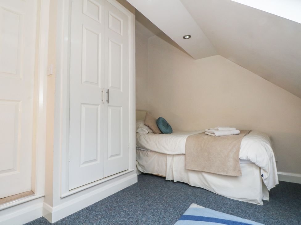 A bedroom with a bed and wardrobe at Cragg Hall View in Cragg Vale