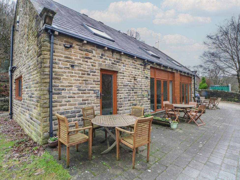 An outdoor patio with furniture at Cragg Hall View in Cragg Vale
