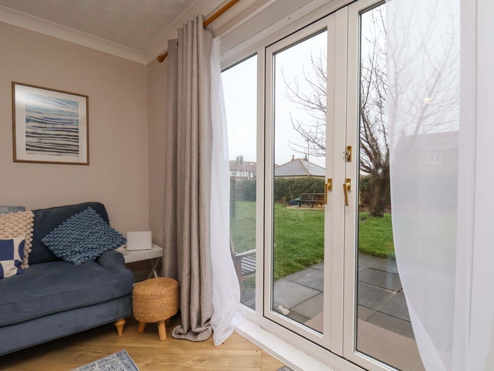 A living room with a sofa and window at Flat 1, 40 Hinderwell Lane