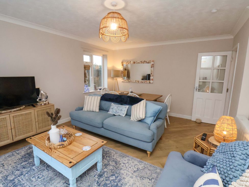 A living room with a sofa and television at Flat 1, 40 Hinderwell Lane