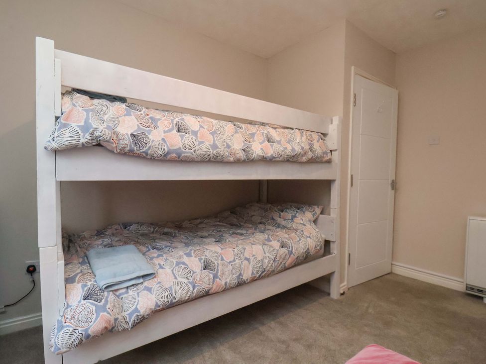 A bunk bed with bedding in a bedroom at Flat 1, 40 Hinderwell Lane