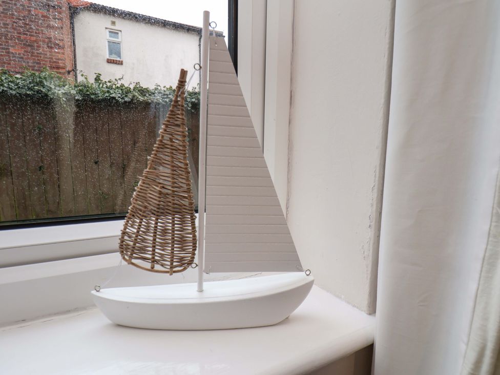 A model sailboat on a window sill at Flat 1, 40 Hinderwell Lane