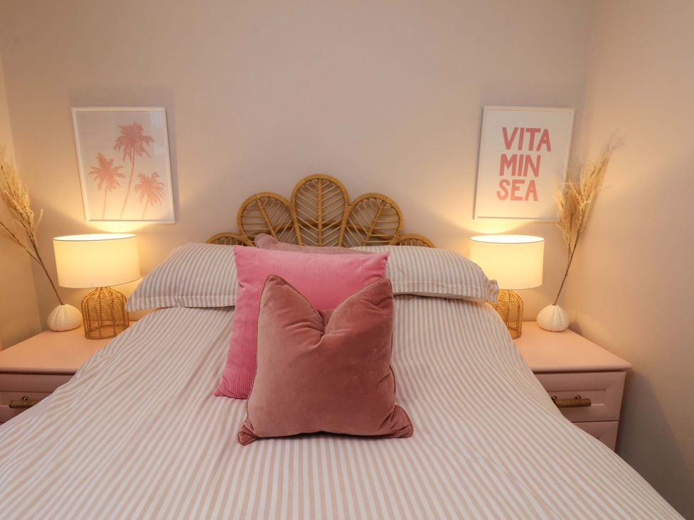 A bedroom with a bed and decorative items at Flat 1, 40 Hinderwell Lane