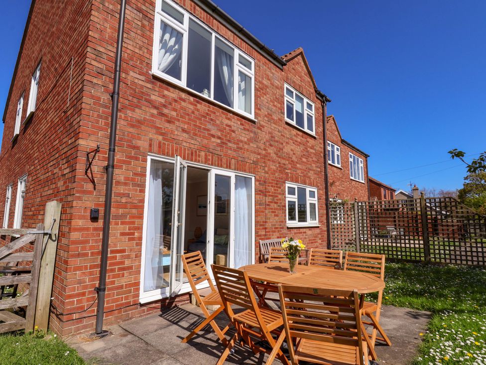 A dining area with a table and chairs at Seashells at Runswick Lodge Runswick Bay