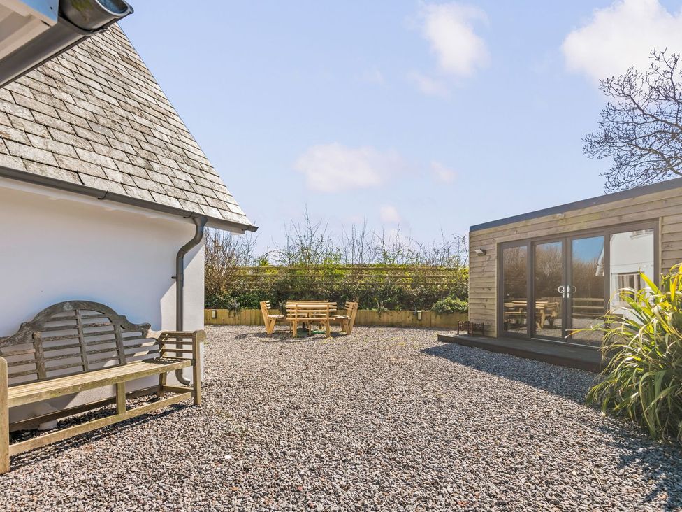 A garden with bench and wooden table at Capton Snug Dartmouth
