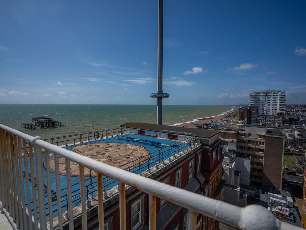 An outdoor view of the ocean and pier from a building at Beachfront Penthouse Brighton