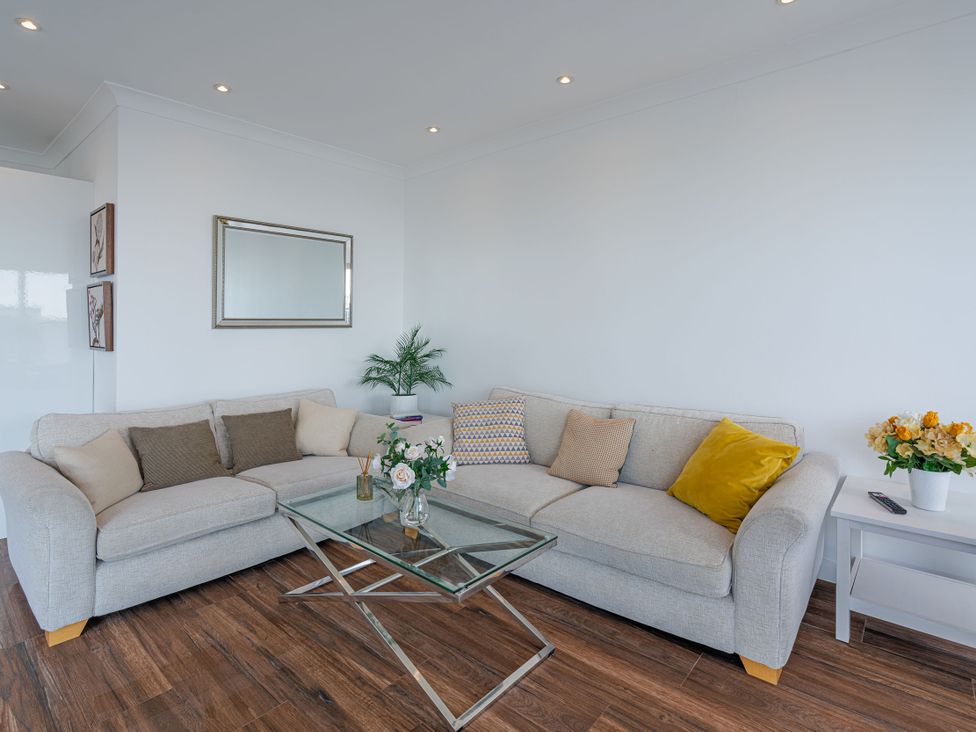 A living room with a sofa and coffee table at Beachfront Penthouse in Brighton