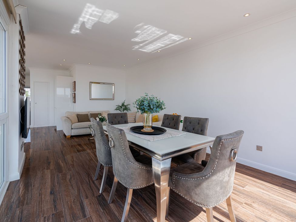 A dining room with a table and chairs at Beachfront Penthouse Brighton
