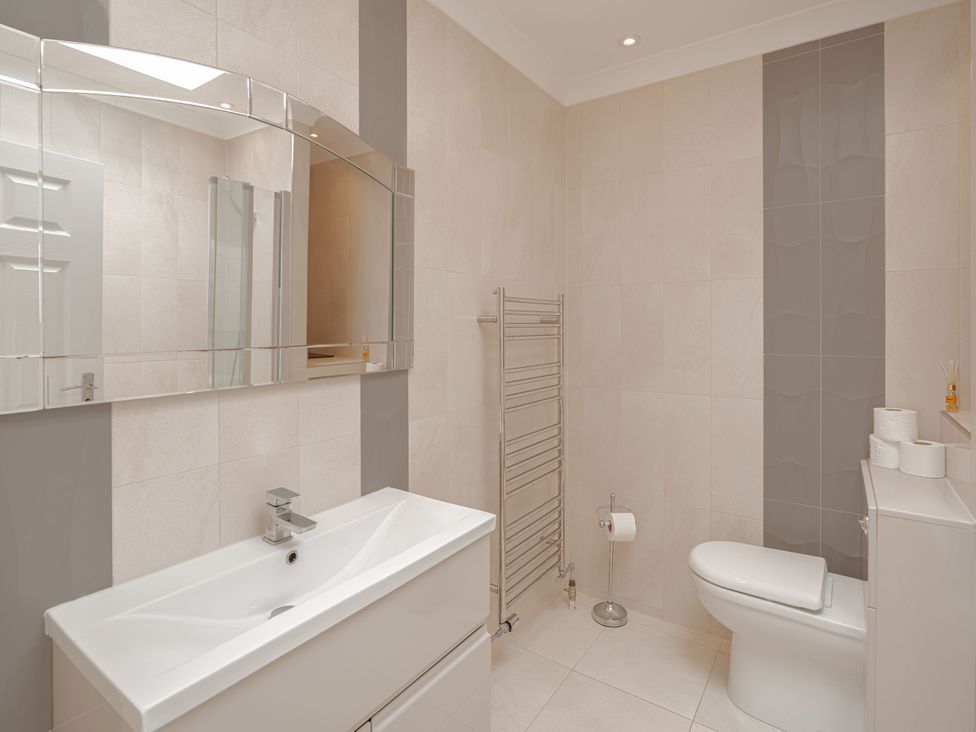 A bathroom with a sink and toilet at Beachfront Penthouse in Brighton