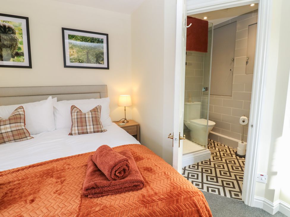 A bedroom with a bed and bathroom visible at Olive Cottage in Richmond