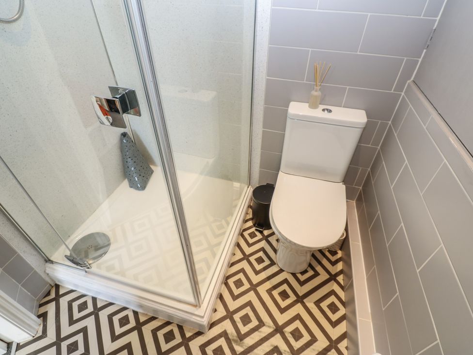 A bathroom with a shower and toilet at Olive Cottage in Richmond
