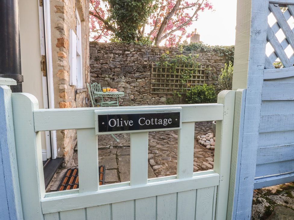 An outdoor area with a gate and furniture at Olive Cottage in Richmond