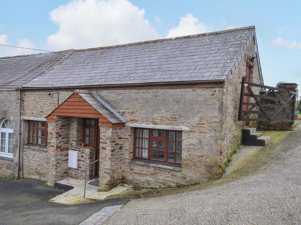 A stone building with windows and a door at Casa Mia in Porthpean near St Austell