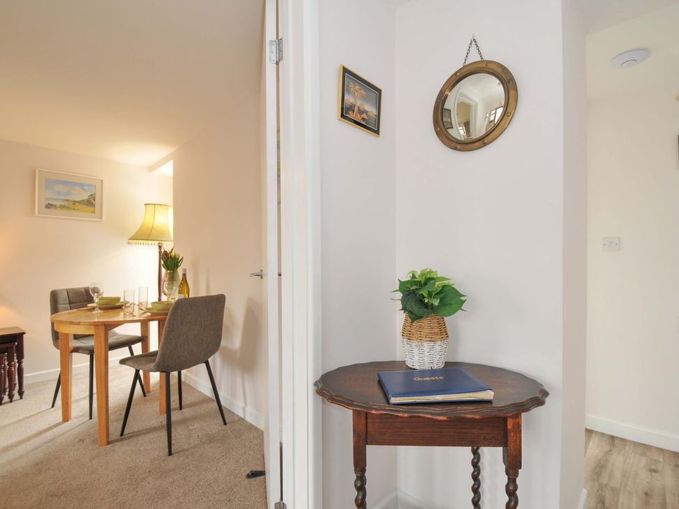A dining area with a table and chairs at Casa Mia in Porthpean near St Austell