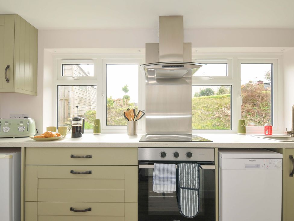 A kitchen with an oven and dishwasher at Casa Mia near Porthpean