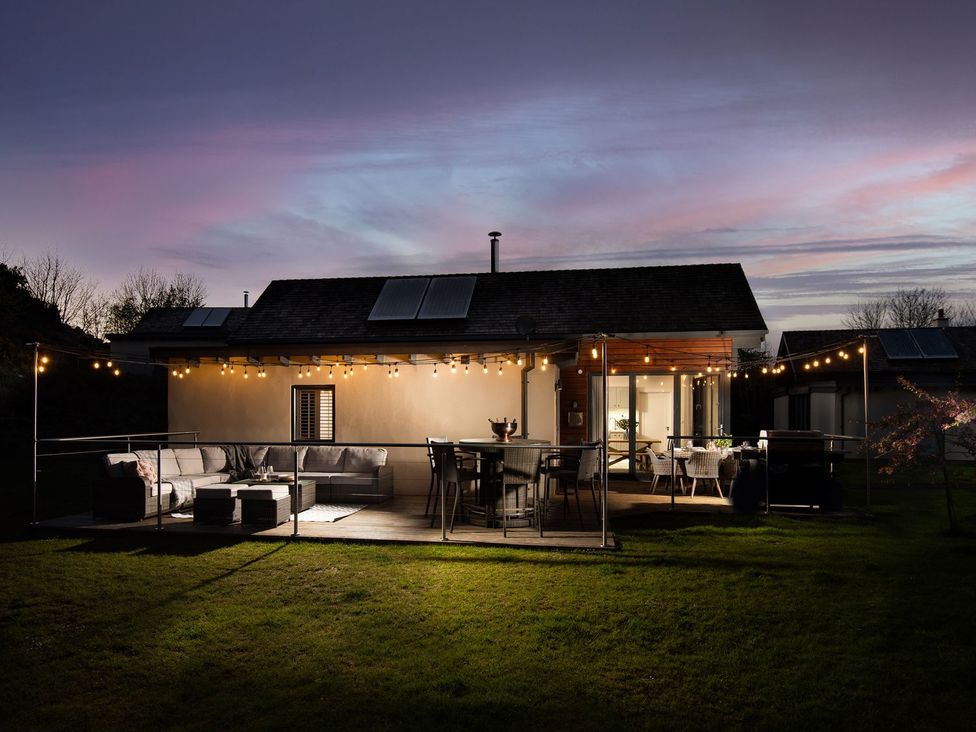 A house with outdoor seating and lights at Summerset Lodge