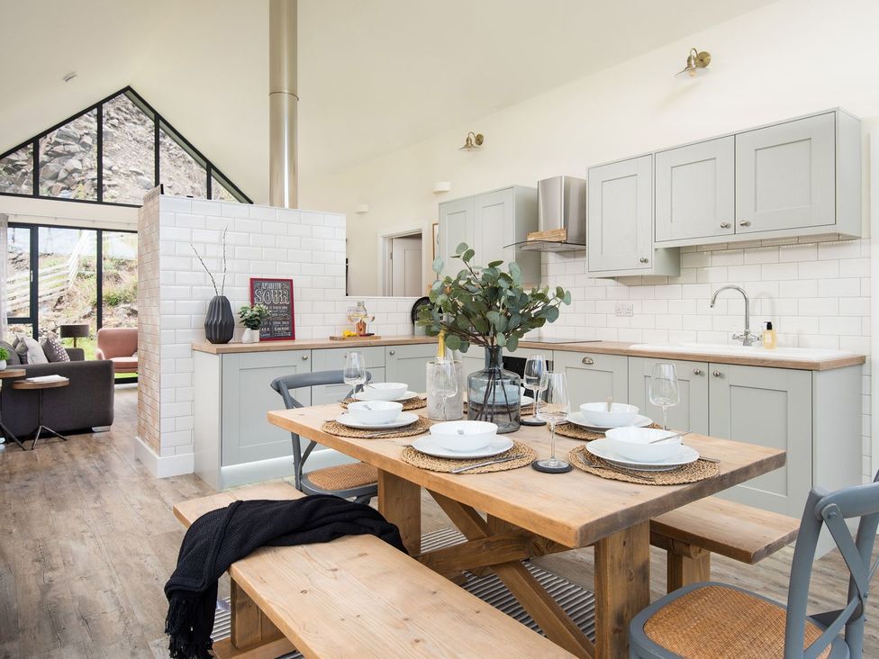 A kitchen with a dining table and chairs at Summerset Lodge