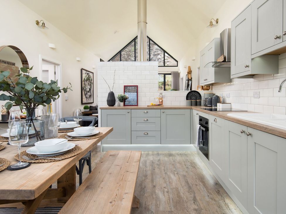 A kitchen with a dining table and chairs at Summerset Lodge