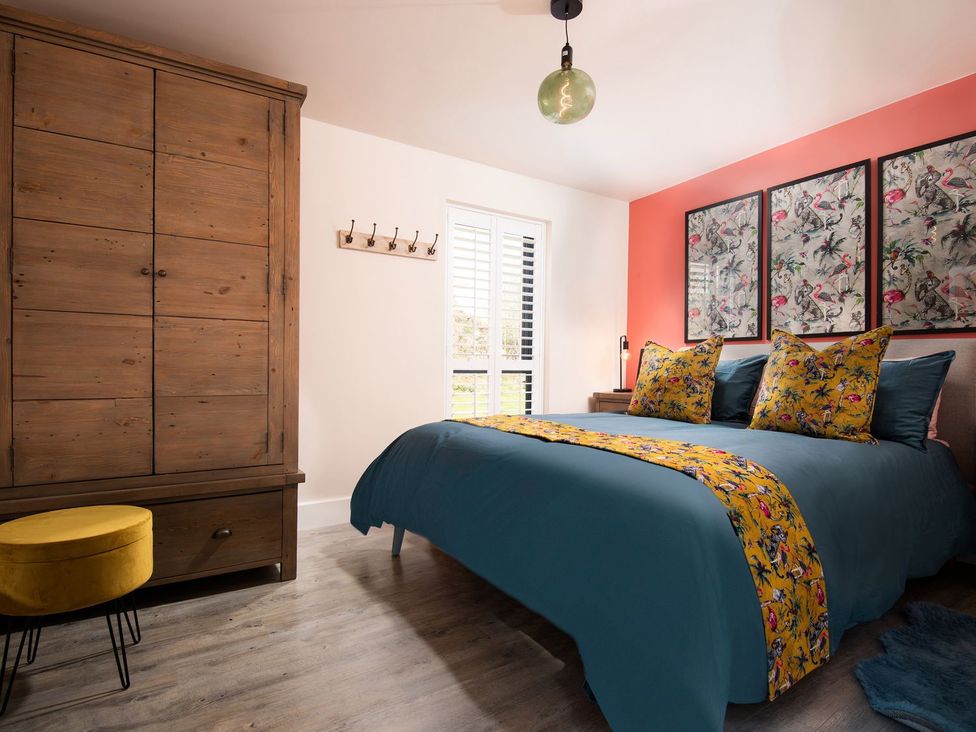 A bedroom with a bed and wardrobe at Summerset Lodge
