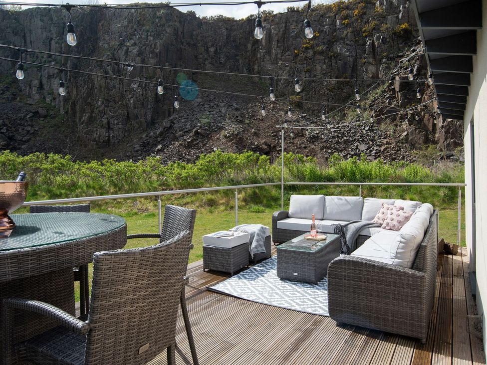 An outdoor seating area with a sofa and table at Summerset Lodge 