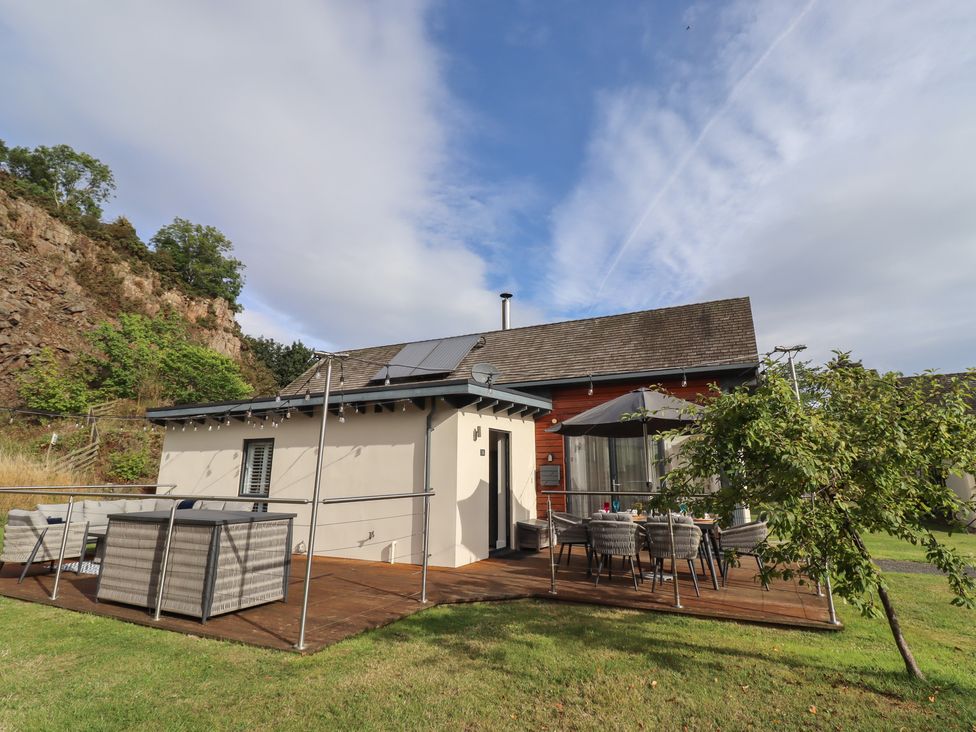 A house with decking and furniture at Summerset Lodge in Bamburgh