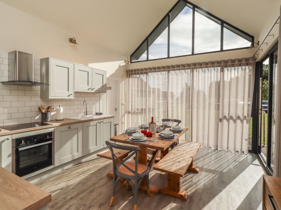 A kitchen with table and chairs at Summerset Lodge Bamburgh