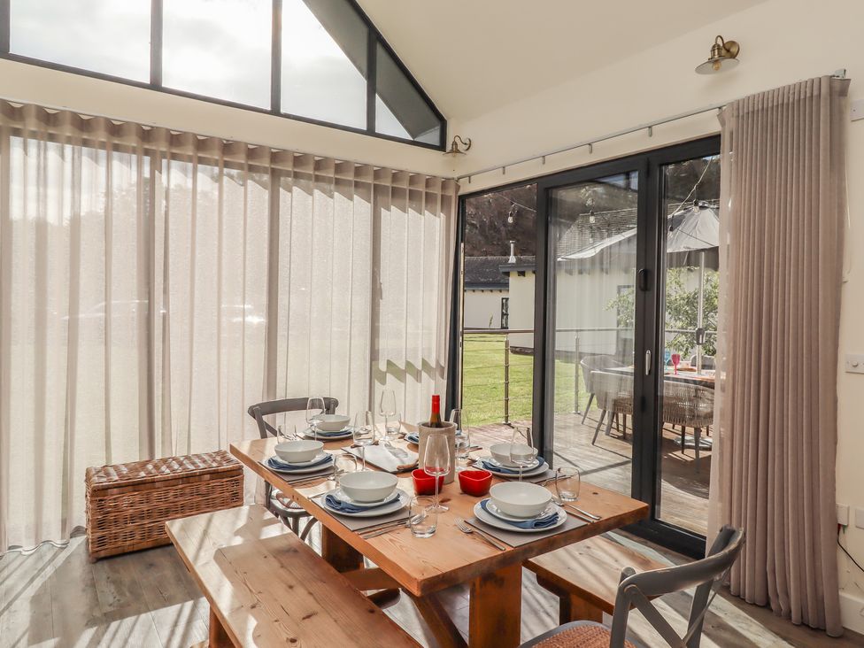 A dining room with a table set for a meal at Summerset Lodge Bamburgh