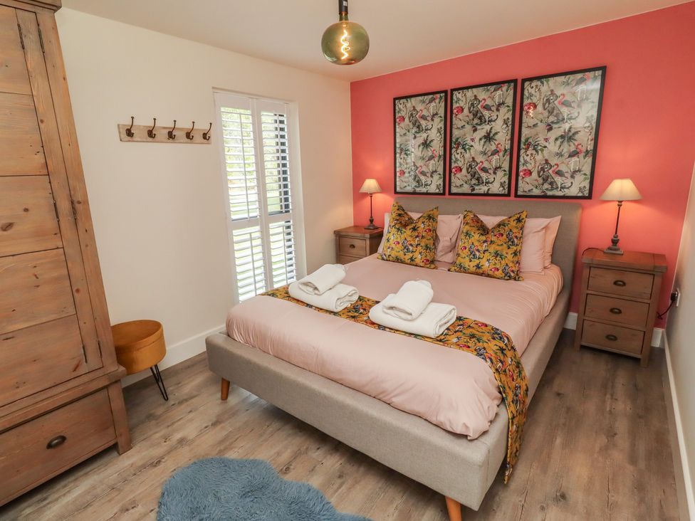 A bedroom with a bed and bedside tables at Summerset Lodge in Bamburgh