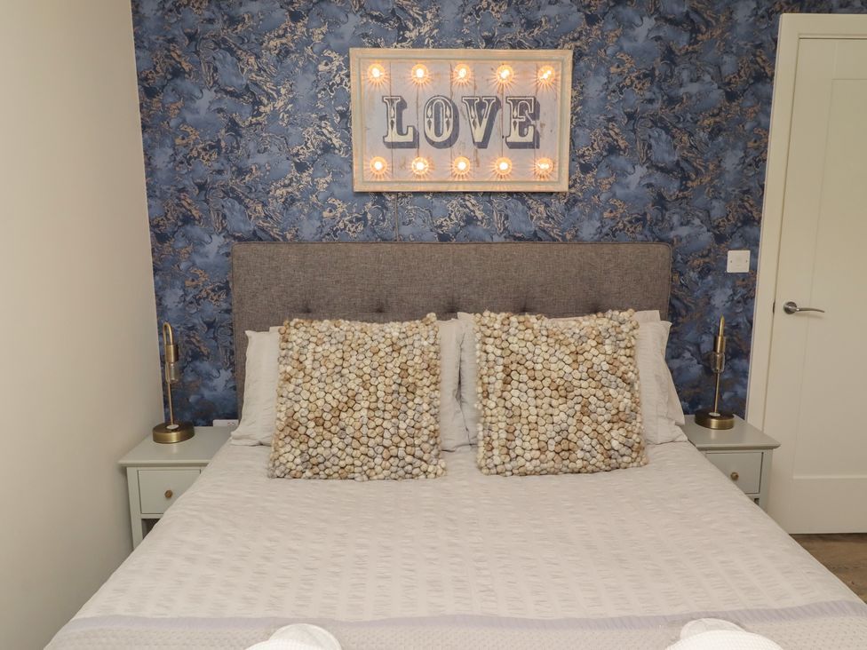 A bedroom with a bed and bedside tables at Summerset Lodge in Bamburgh