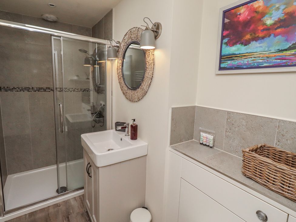 A bathroom with a shower and sink at Summerset Lodge in Bamburgh