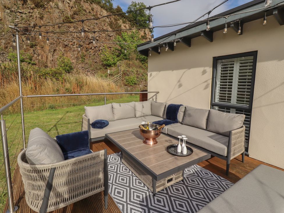 An outdoor seating area with a sofa and coffee table at Summerset Lodge in Bamburgh