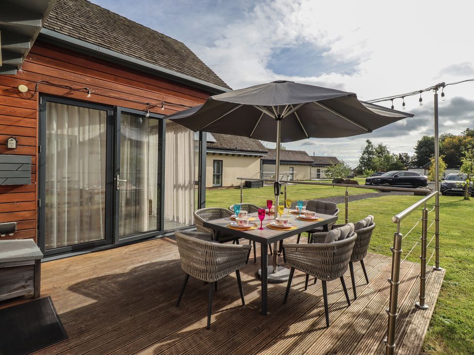 A dining area with a table and chairs at Summerset Lodge in Bamburgh