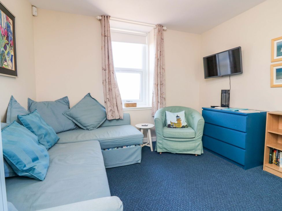 A living room with a sofa and television at The Flaghouse at The Lighthouse St Abbs